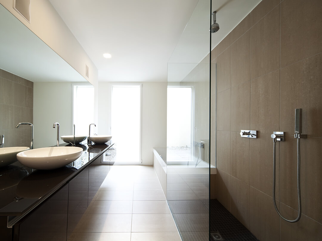Walk-in-Dusche bestehend aus einer Glaswand vor großem Spiegel