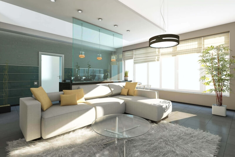 Hellblaue Glastrennwand zwischen offener Küche und Wohnbereich