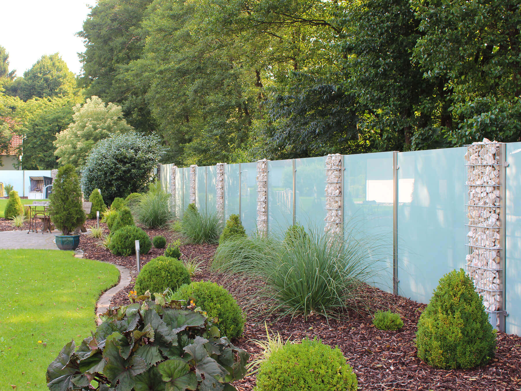 Wind- & Sichtschutz mit seitlichen Glasklemmen mit Gabionenzaun